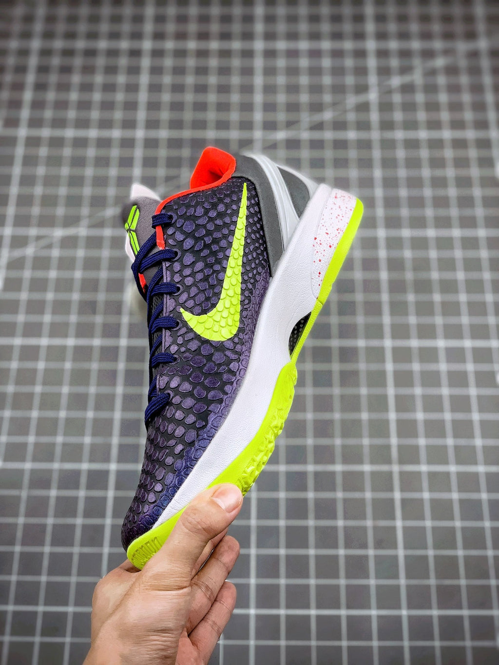 Navy basketball sneaker with neon green outsole and swoosh, red collar and tongue