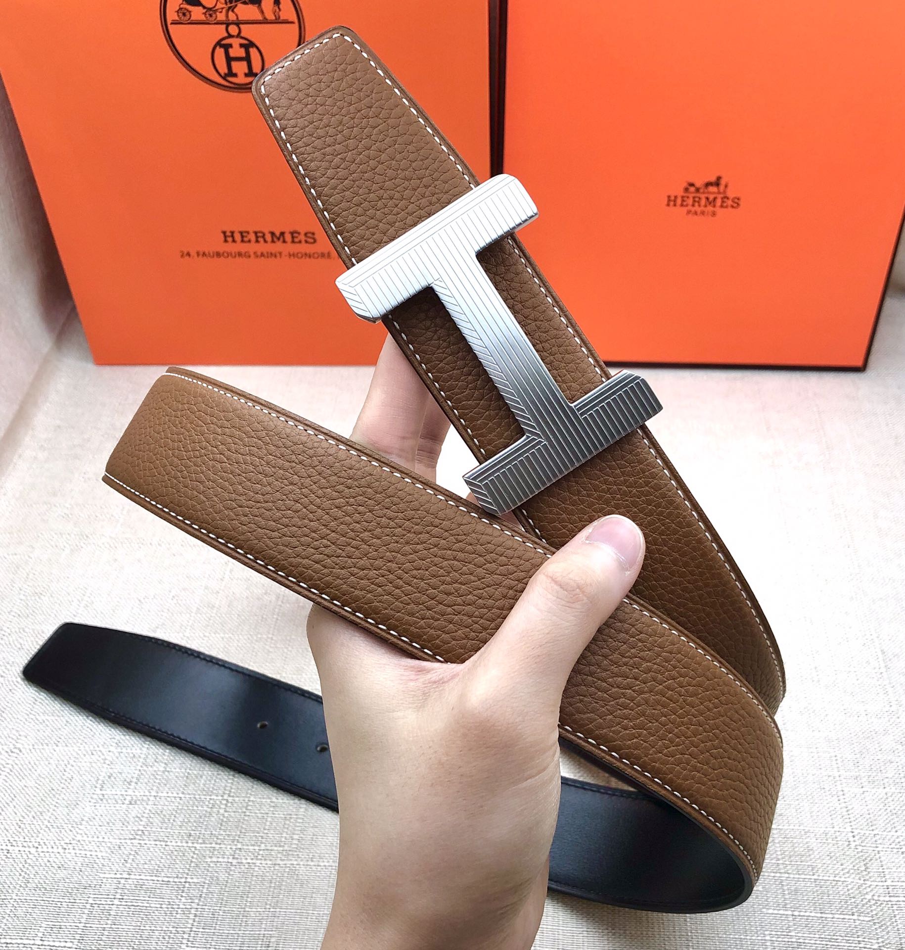 Brown leather belt with cream H buckle and stitched edge