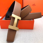 Brown leather belt with cream H-style buckle and visible strap holes