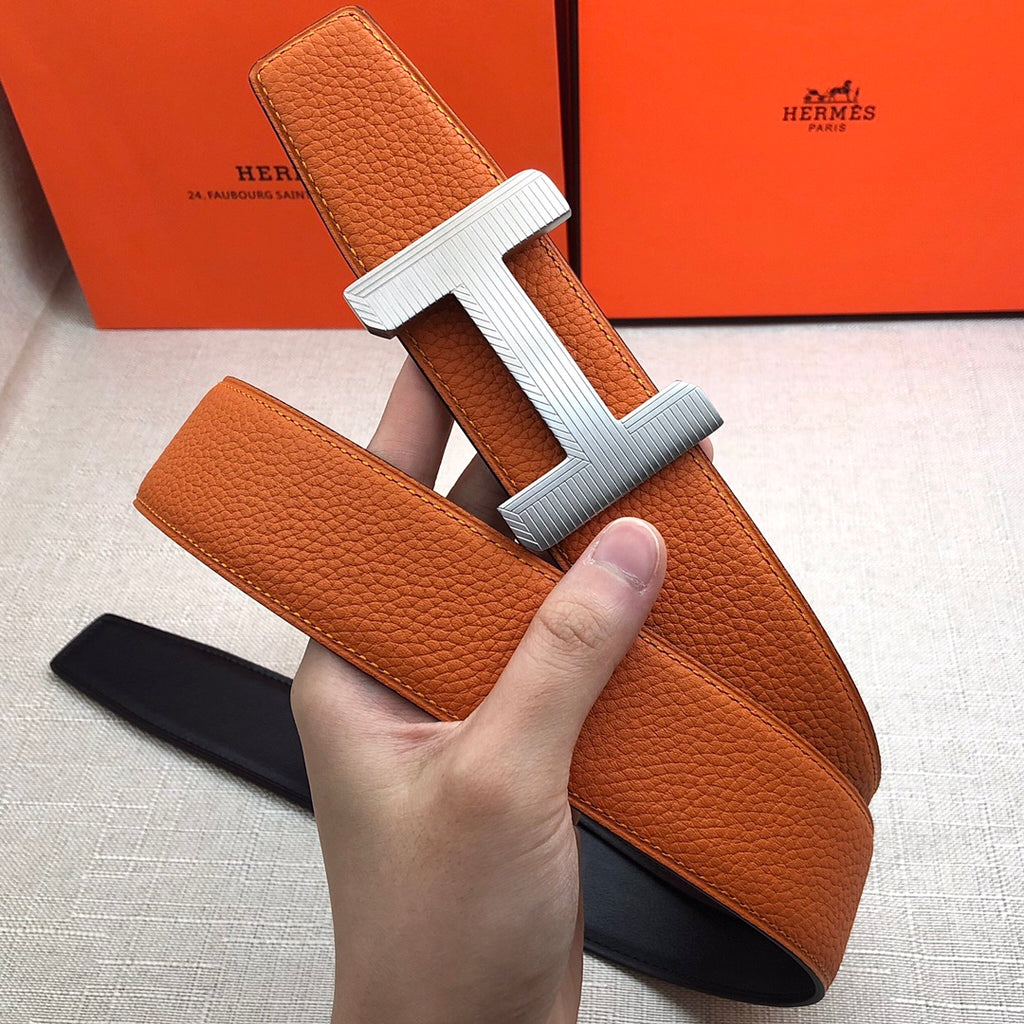 Hermes belt orange leather with silver H buckle and black underside