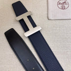 Navy leather belt with silver-tone H buckle; matching strap with two visible keeper holes.