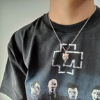Lion head pendant necklace on silver chain worn on dark T-shirt
