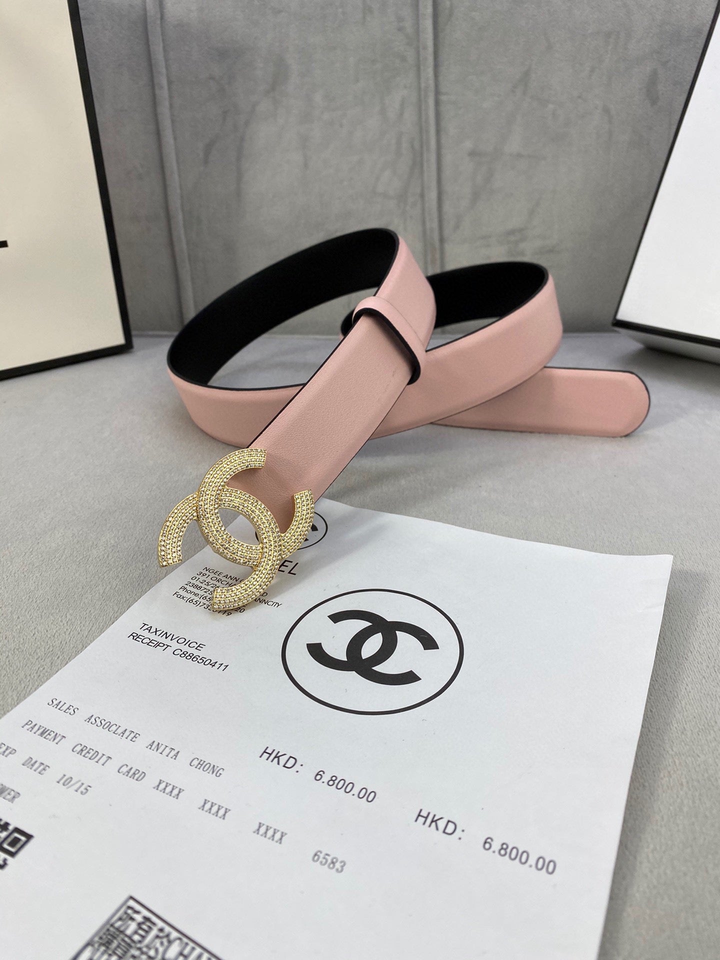Chanel belt with light pink strap and oversized rhinestone CC buckle on black backing