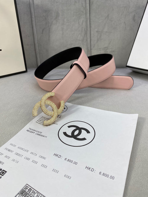 Chanel belt with light pink strap and oversized rhinestone CC buckle on black backing