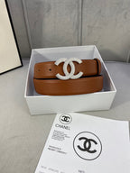 Tan leather belt with rhinestone CC buckle and matching holes, in a box.