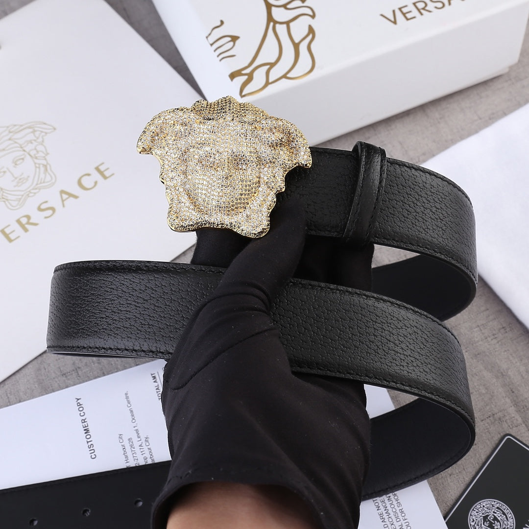 Black leather belt with gold-tone Medusa buckle and embossed texture.
