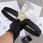 Black leather belt with gold-tone Medusa buckle, adjustable holes.