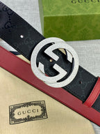 Gucci belt close-up, black monogram strap with silver circular buckle