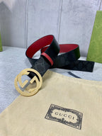 Gucci belt on display, black monogram strap with gold double-G buckle