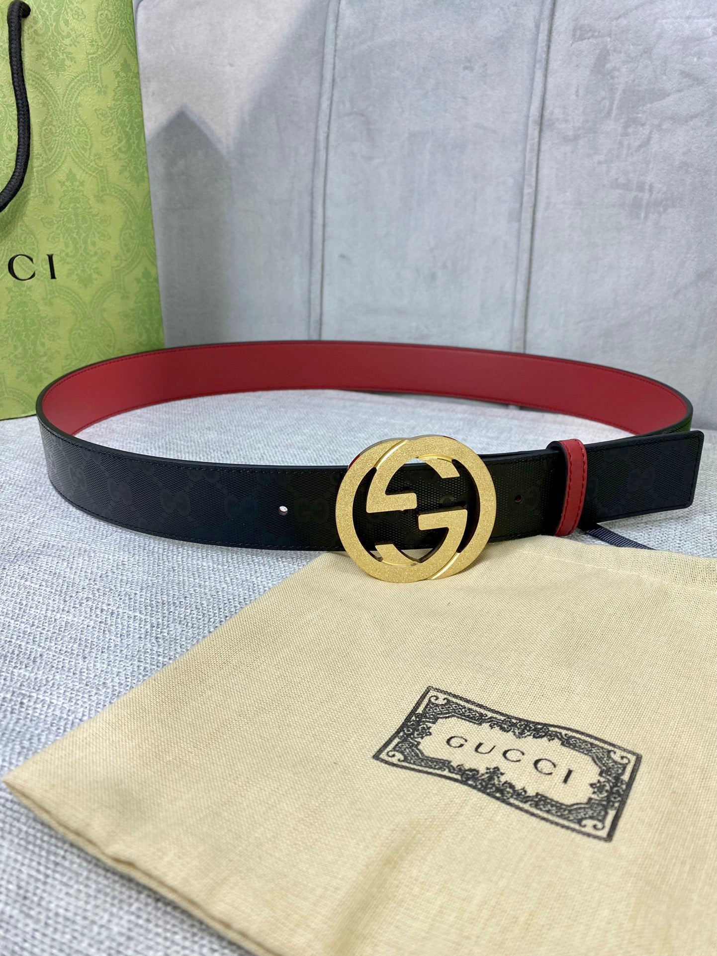 Gucci belt with black monogram strap and gold double-G buckle
