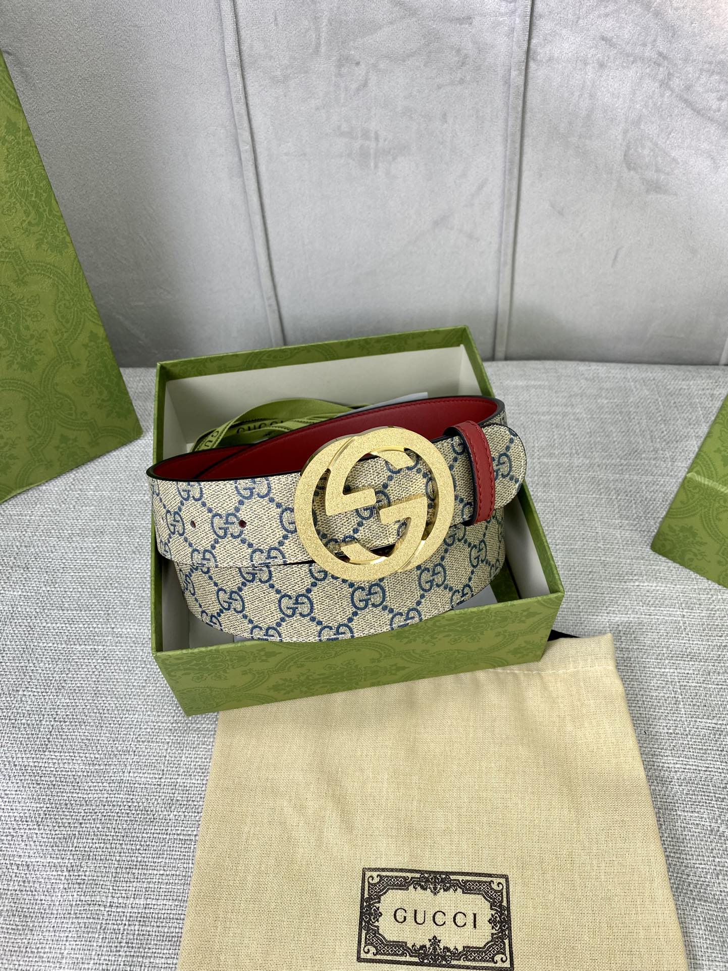 GG canvas belt with red leather edge and gold-toned interlocking buckle in box