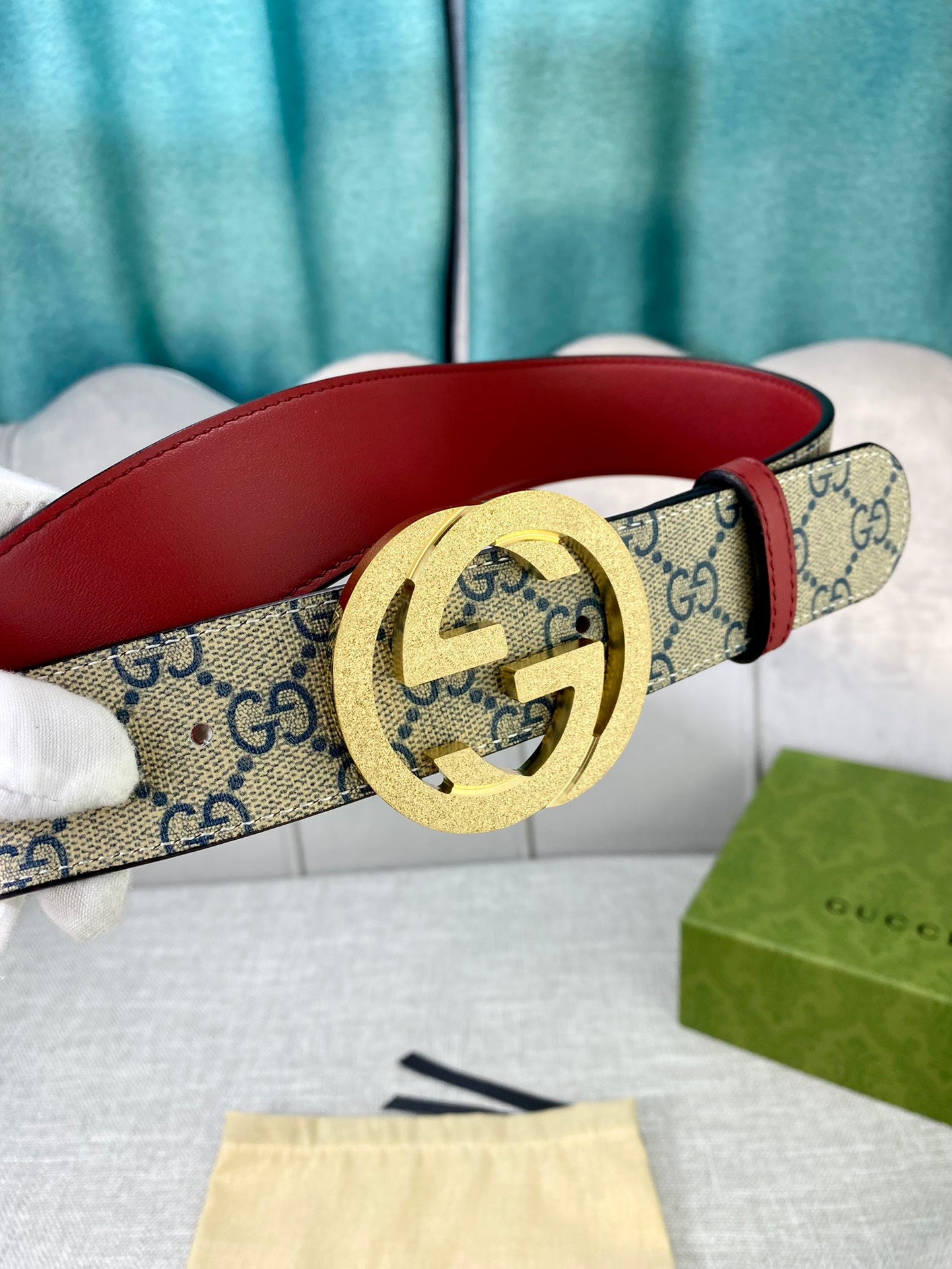GG canvas belt with red leather strap and gold-toned interlocking buckle detail
