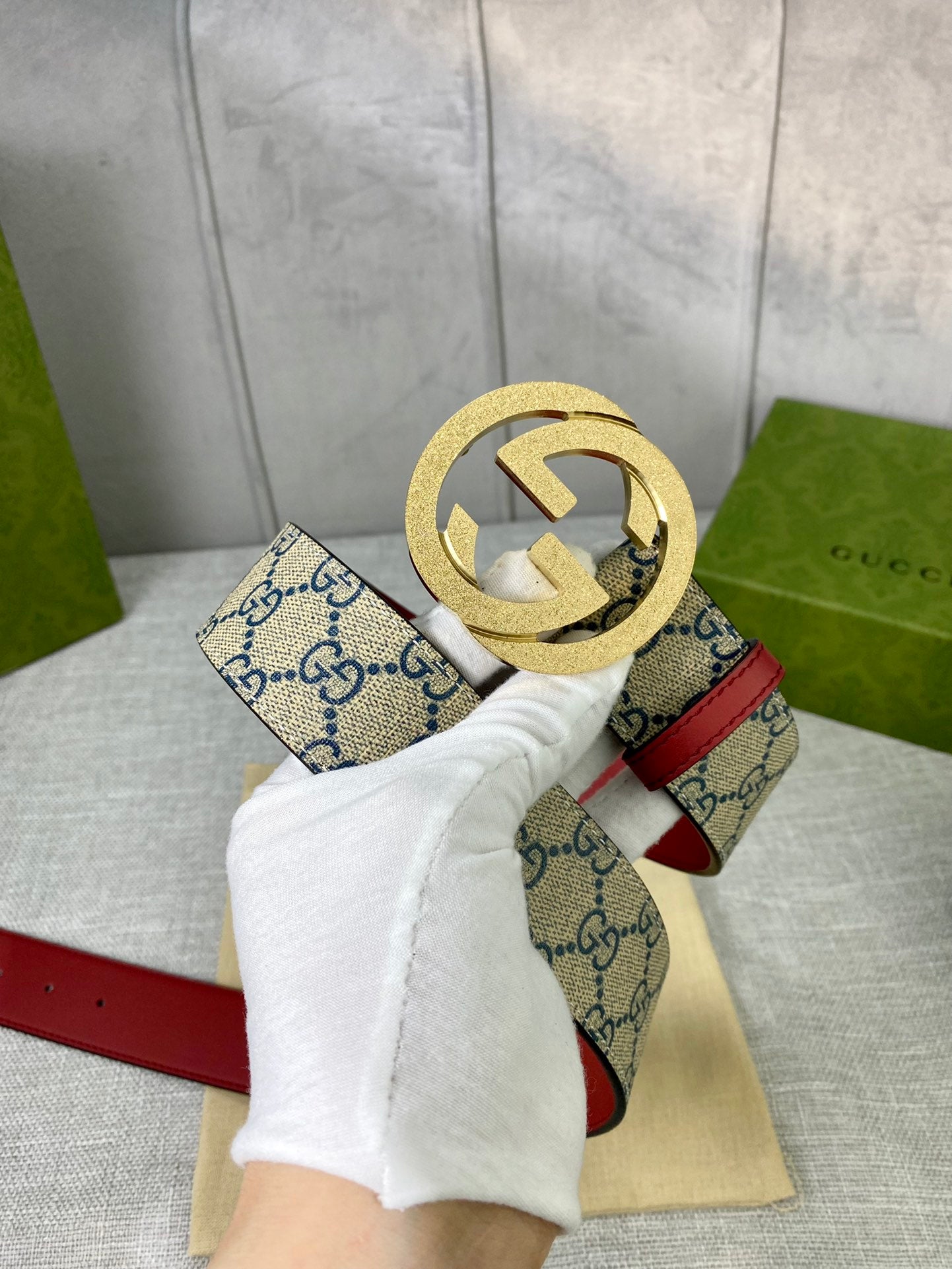 GG canvas belt with red leather trim and gold-toned interlocking buckle close-up