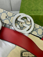Interlocking buckle on GG canvas belt with red leather strap, close detail