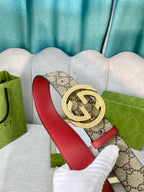 Gucci belt with GG canvas, red leather strap, round gold-toned interlocking buckle