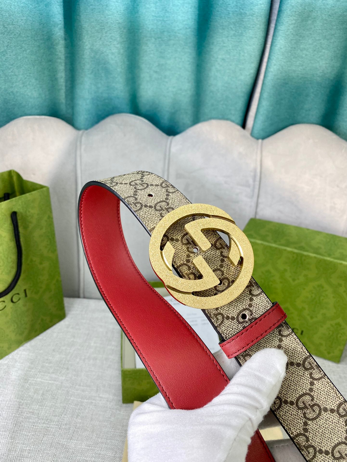 Gucci belt with GG canvas, red leather strap, round gold-toned interlocking buckle