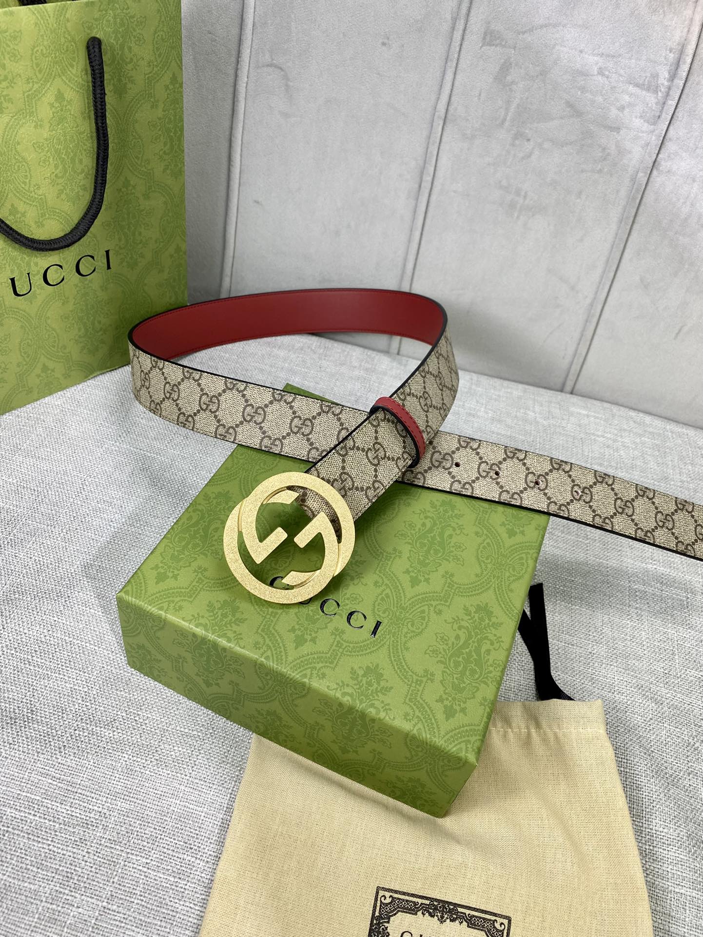 Gucci belt with GG canvas and red leather trim, gold-toned interlocking buckle