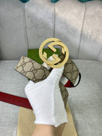 Gucci belt with GG canvas, red leather strap, circular gold-toned interlocking buckle