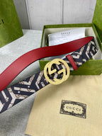 Curved logo-print belt with gold G buckle and red leather edge.