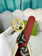 Logo-print belt with gold buckle, red leather panel, black-and-cream webbing.
