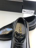Black lace-up shoe showing insole branding and lace-up front