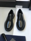 Black lace-up leather shoes with wingtip perforations and thick rubber sole