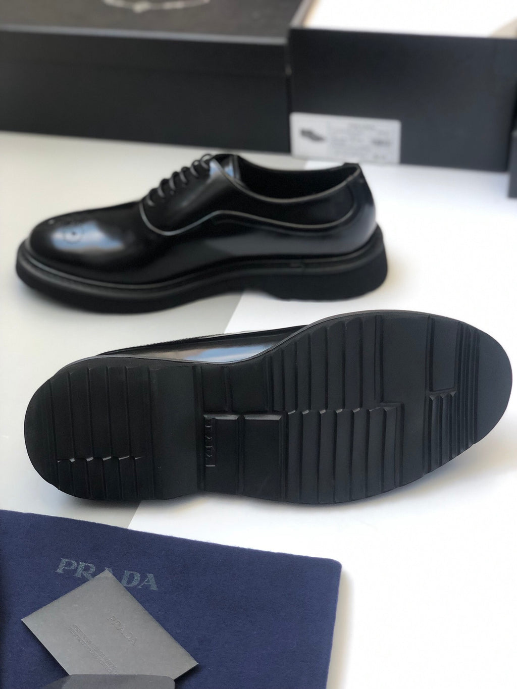 Black lace-up shoe outsole view with textured tread and thick platform sole