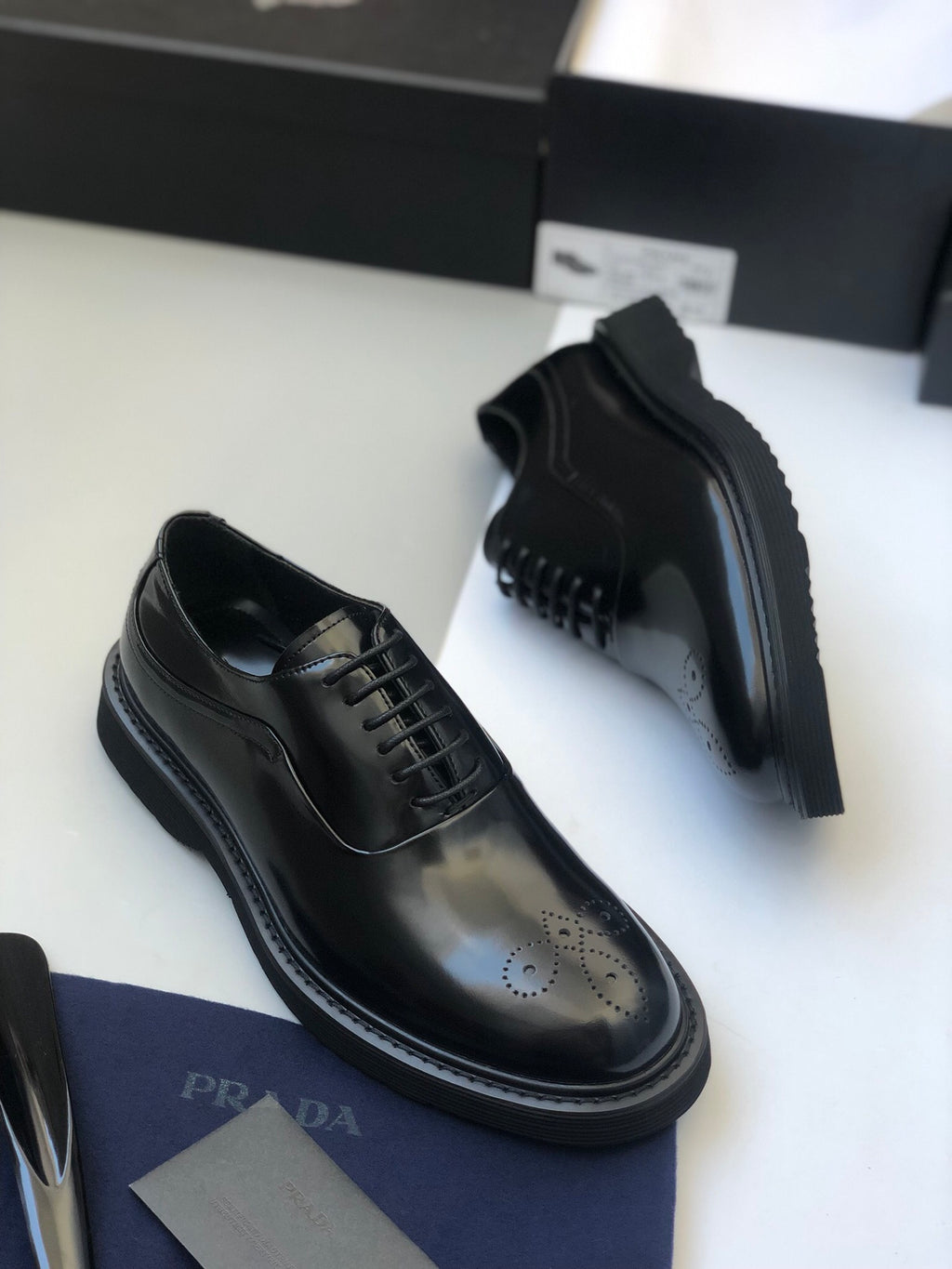 Black lace-up oxford shoes with side panel stitching and thick rubber sole