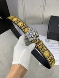 Designer belt with black strap, gold patterned trim, and large silver lion buckle