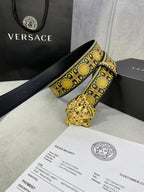 Designer belt with black strap, gold medallion trim, and ornate gold lion buckle