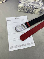 Dior belt with black strap and red underside, silver buckle, visible adjustment holes.