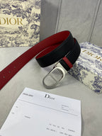 Dior belt coiled: black leather-look strap with red underside and silver buckle.