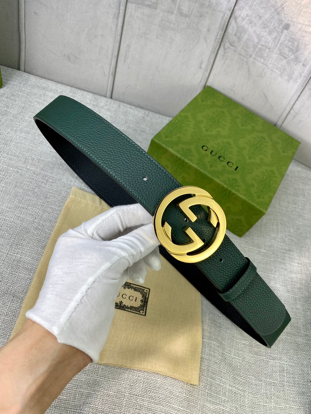 Gucci belt in dark green leather with gold-toned GG buckle and prong