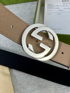 Gucci belt close-up of beige strap and silver double-G buckle with small holes