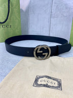 Black leather belt with silver-tone interlocking GG buckle.