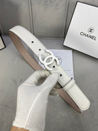 White leather belt with silver CC buckle and perforated adjustment holes