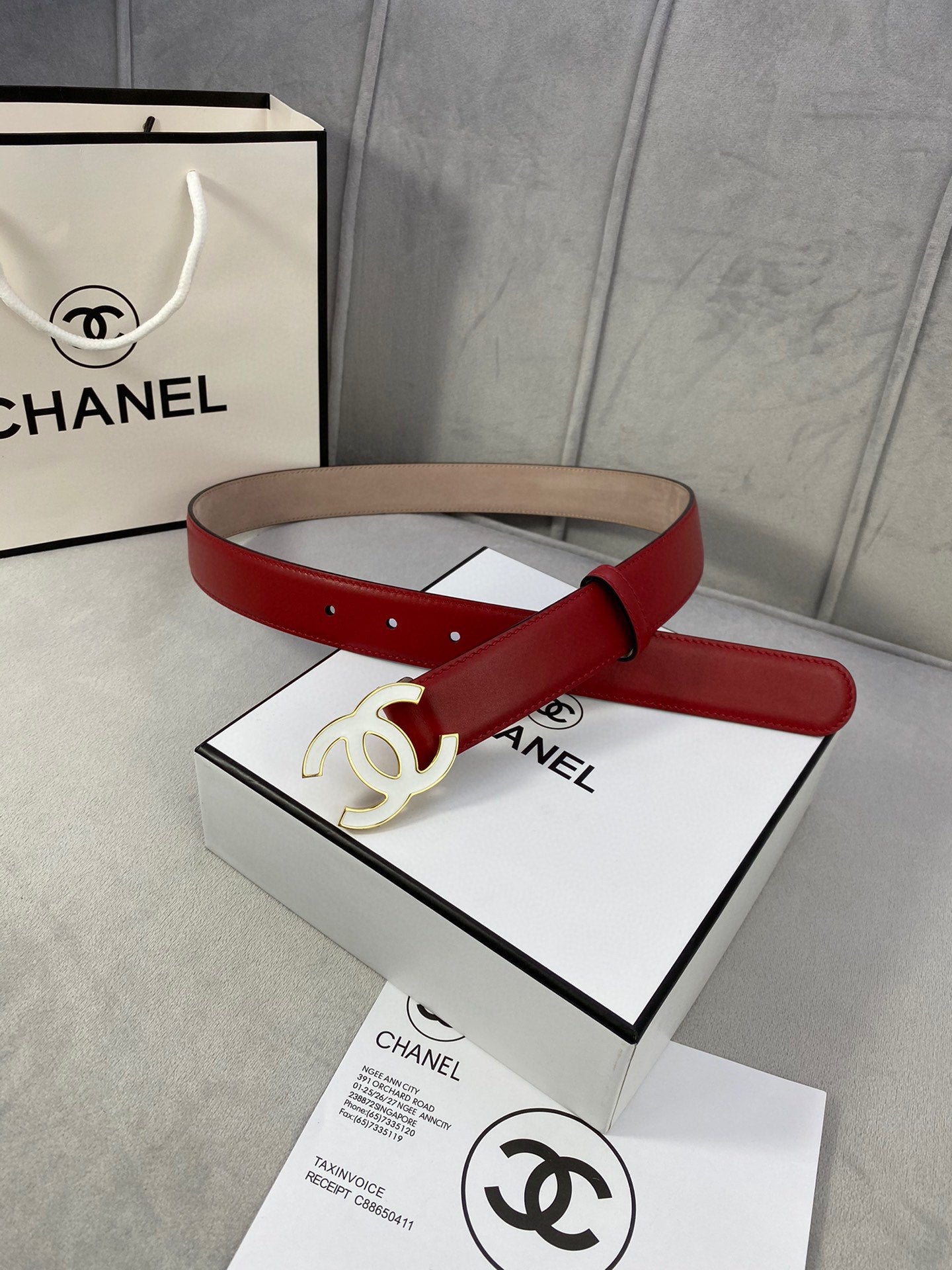 Red leather Chanel belt with gold-tone CC buckle, coiled strap view