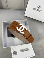 Chanel tan leather belt with gold-tone CC buckle resting in a gift box