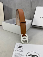 Tan Chanel leather belt upright display with gold-tone CC buckle and punched holes