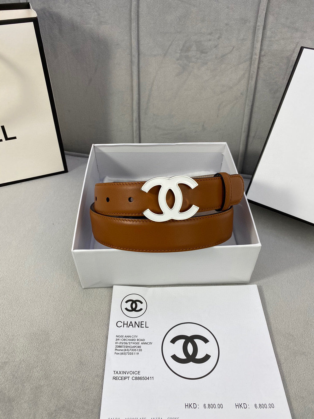 Chanel tan leather belt in a box with gold-tone CC buckle centered on strap