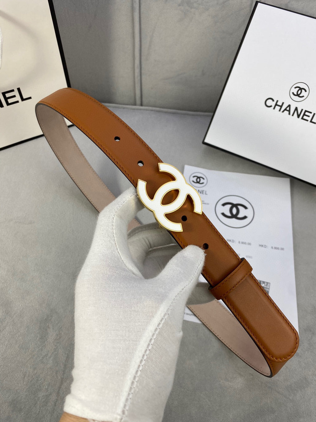 Chanel belt in tan leather with gold-tone interlocking CC buckle and punched holes
