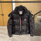 Moncler long puffer jacket front, dark with hood, zip, and hanging size tag