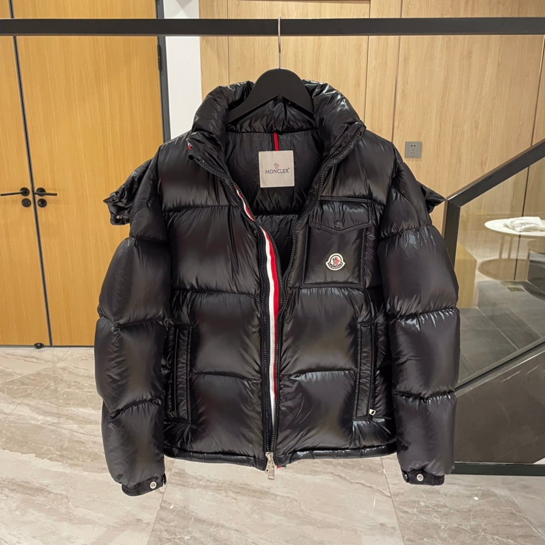 Moncler long puffer jacket front, dark with hood, zip, and hanging size tag