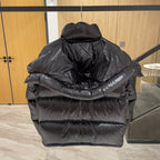 Moncler long puffer jacket back view, dark with padded hood and thick quilting