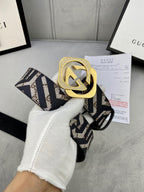Gucci belt with large goldtone interlocking G buckle on navy/beige GG strap