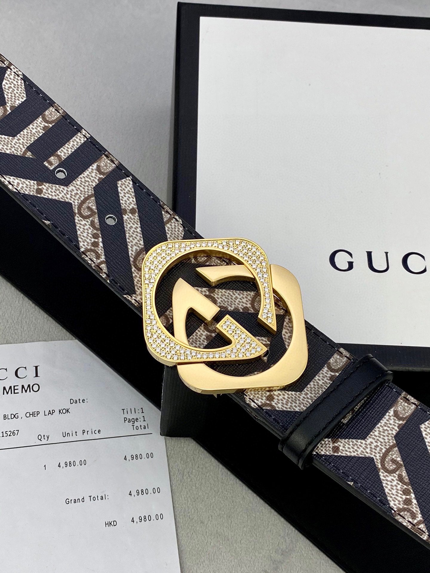Gucci belt detail: goldtone interlocking G buckle on navy/beige GG strap