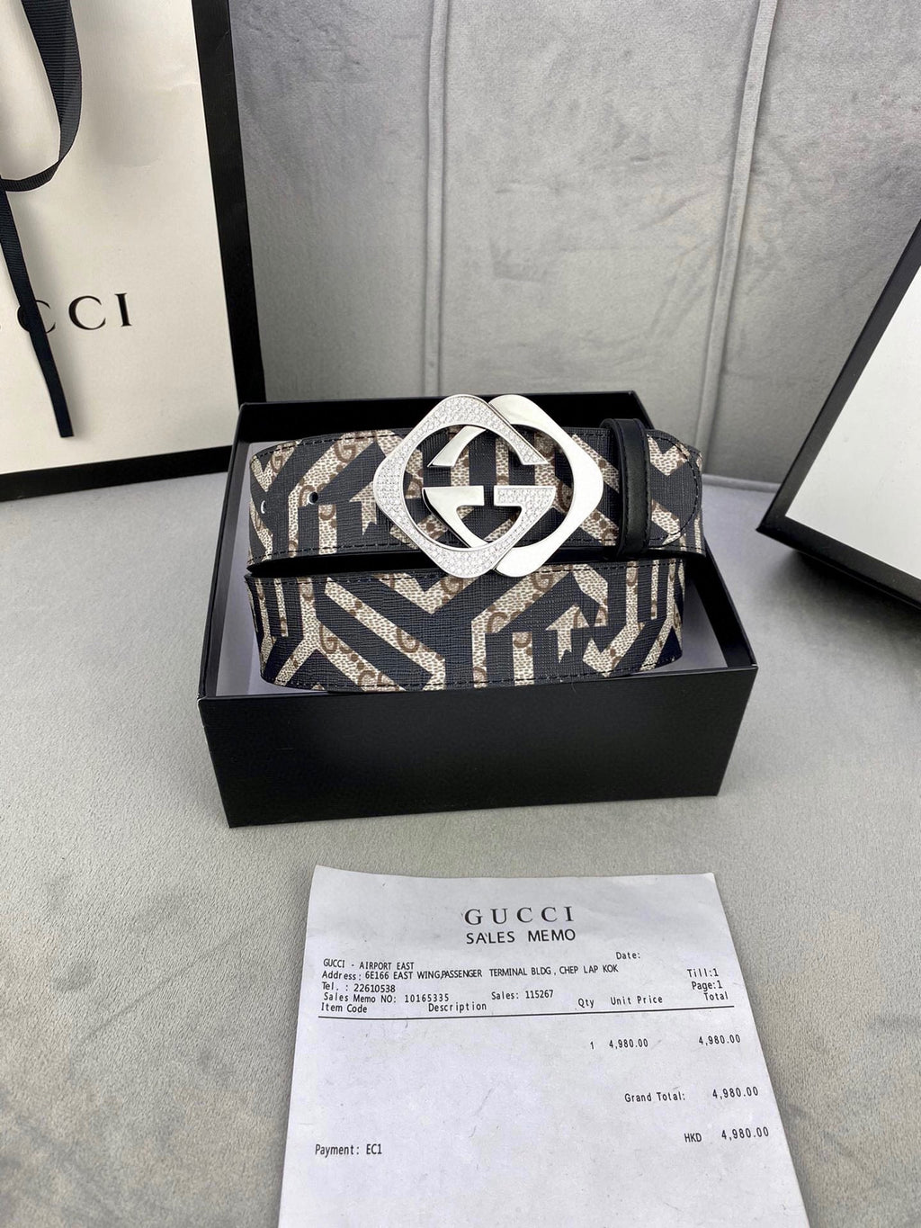 Gucci belt on box with navy/beige GG strap and metallic interlocking G buckle