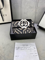Gucci belt on box with navy/beige GG strap and metallic interlocking G buckle