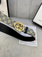 GG monogram belt with navy strap, gold-tone buckle, and black leather strap beneath