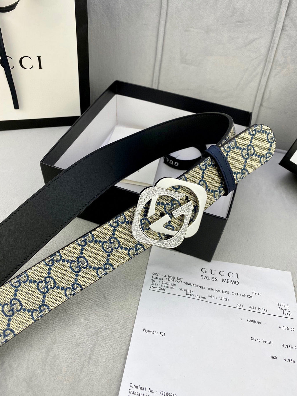 Designer belt with blue GG monogram strap, black leather reverse, gold-tone buckle
